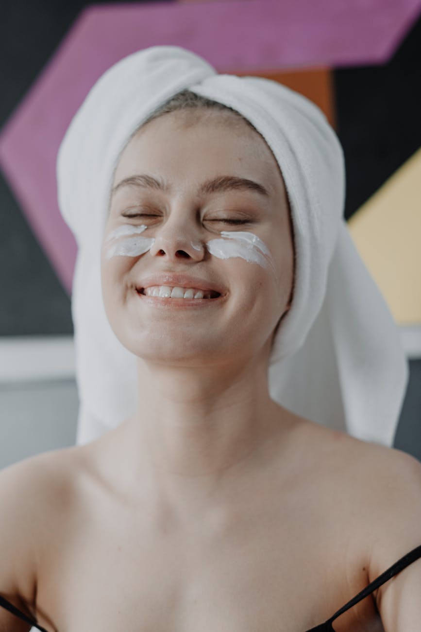 smiling woman with white towel on head