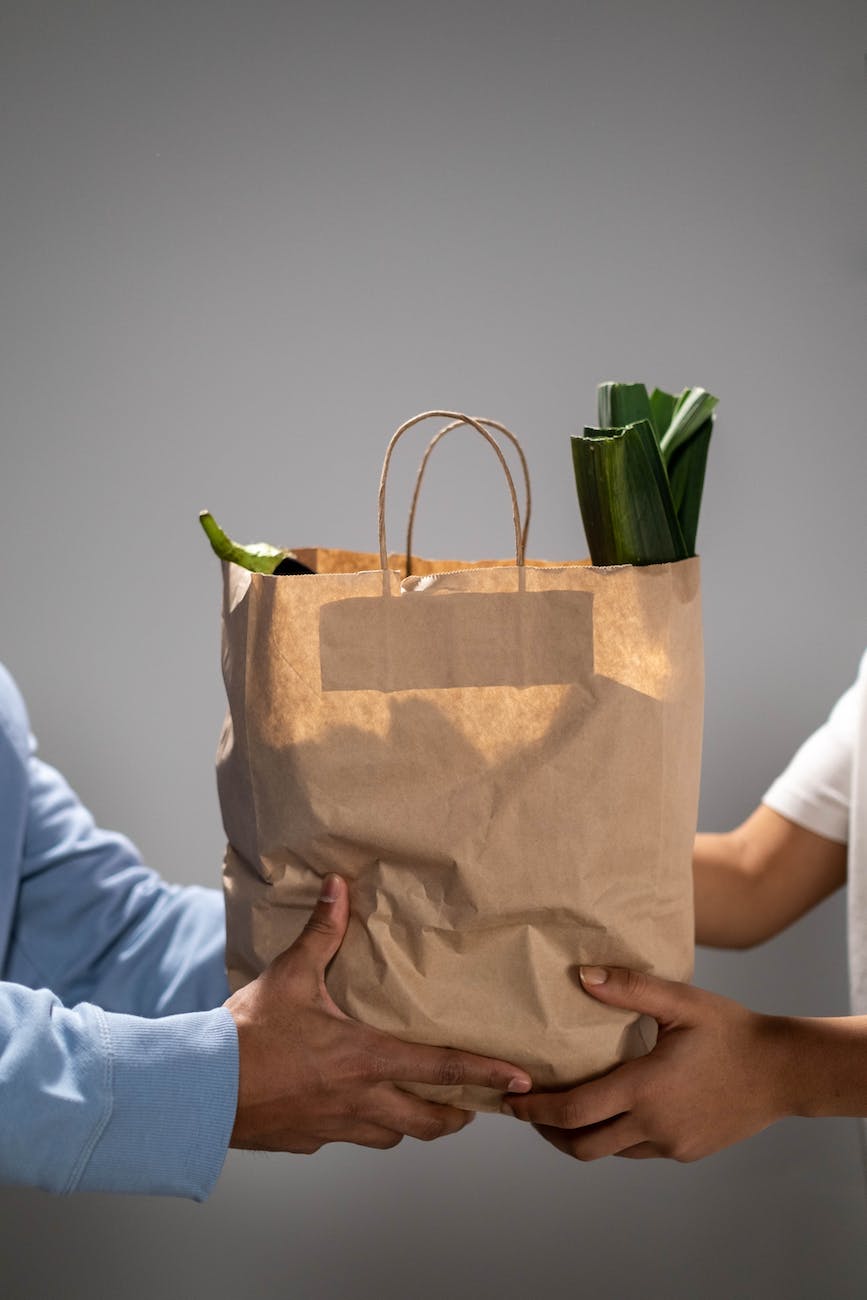 distributing a bag of food aid to a beneficiary