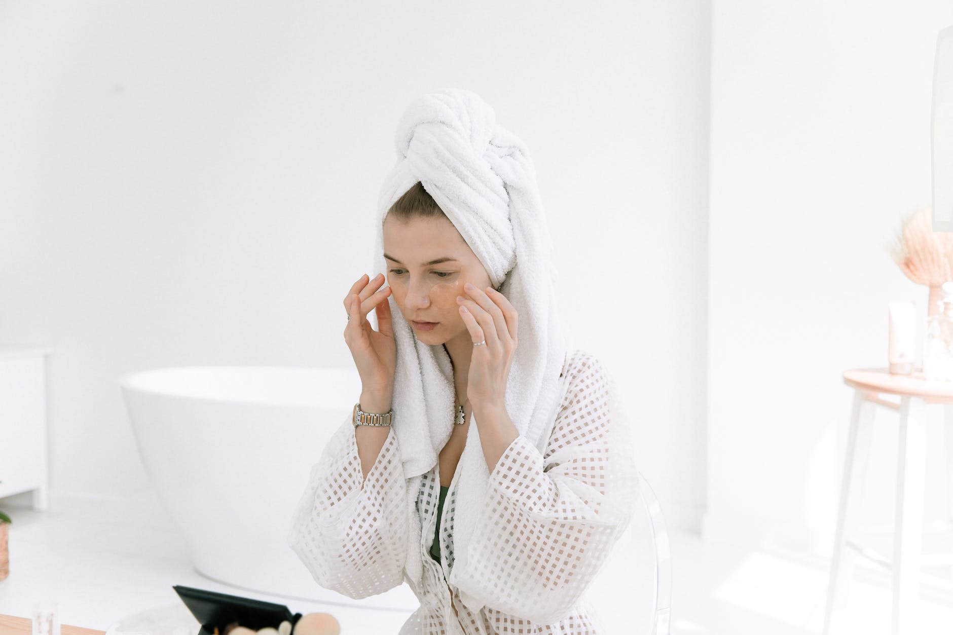 photo of woman touching her face