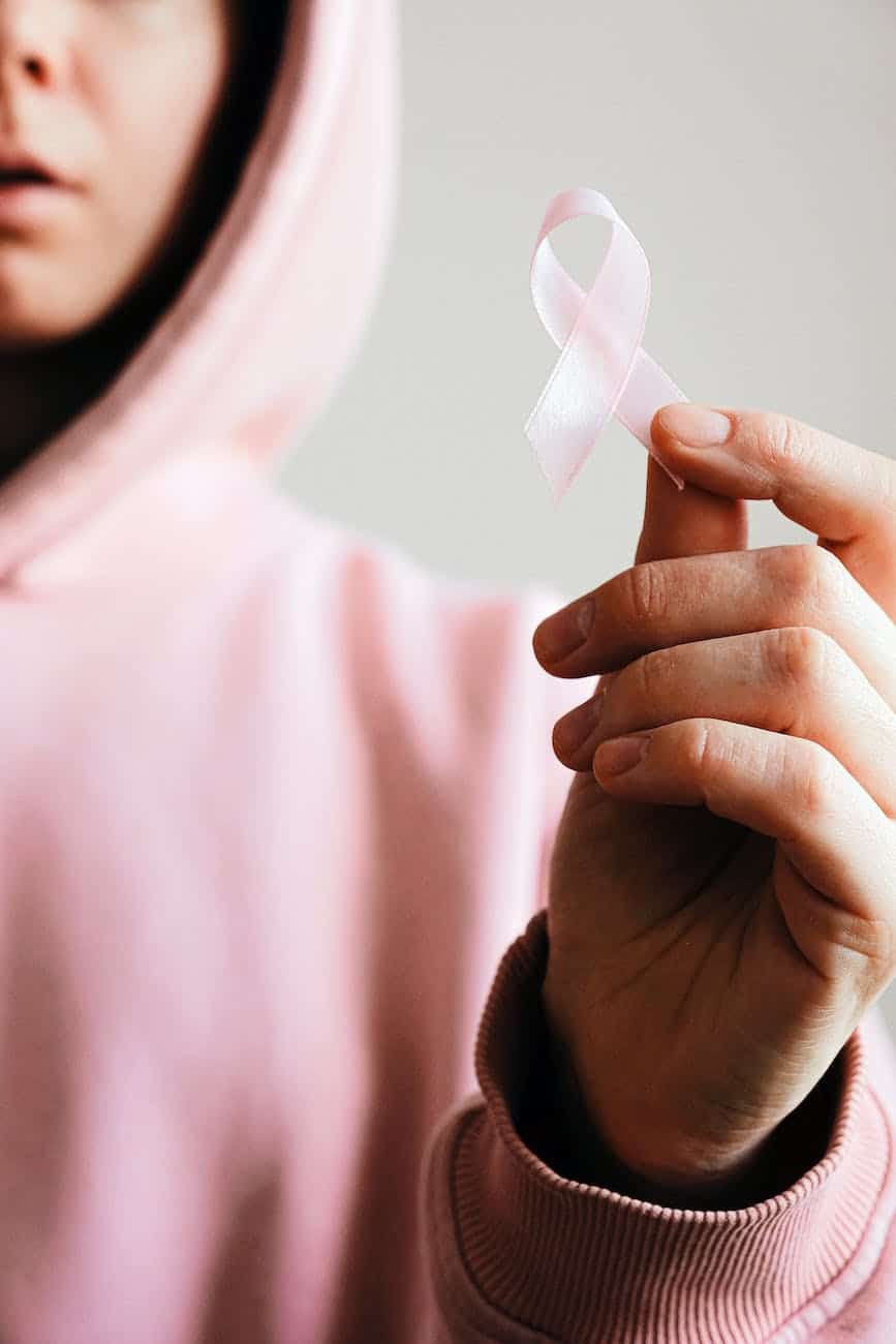 woman holding pink ribbon